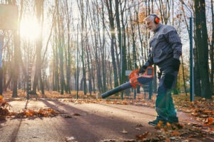 man leaf blowing with ear protection