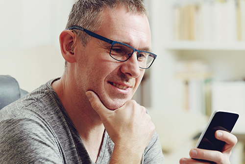 Adult Reading Article on Phone